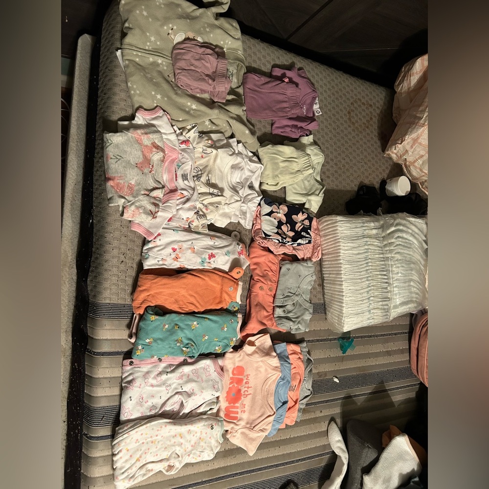 Gently used and brand new baby clothes and diaper pack.